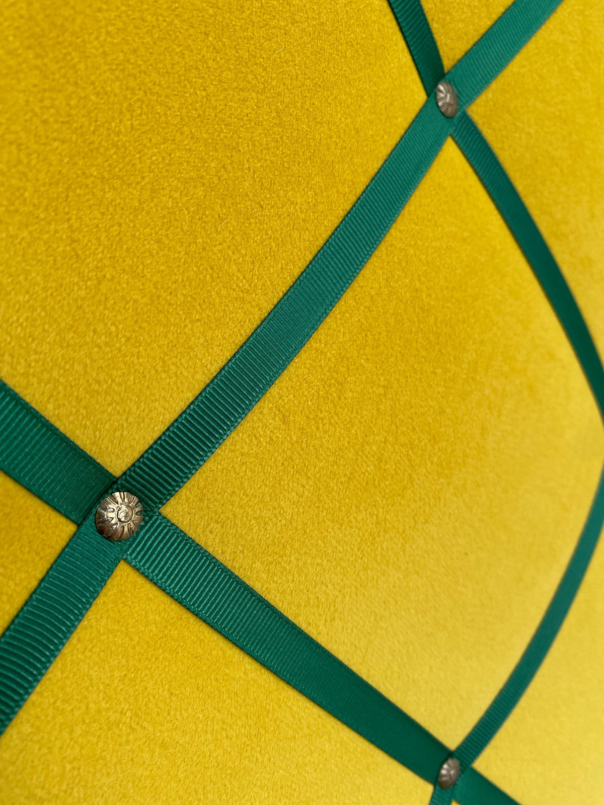 Yellow velvet fabric noticeboard for memos, photos, business cards. Green ribbon in square grid pattern. Great display board.
